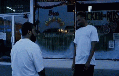 Two Men In Front Of Chicken Shop GIF