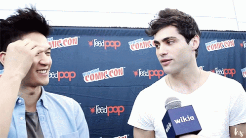 Two Men in Front of Comic Con Wall