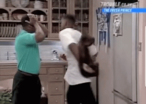 Two Men in Front of Refrigerator With Sign Saying The Fresh Prince