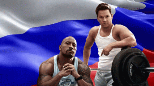 Two Men In Front Of Russian Flag One Holding Barbell GIF