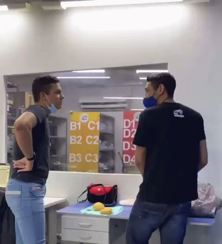 Two Men In Front Of Sign B1 C1 B2 C2 B3 C3 D4 GIF