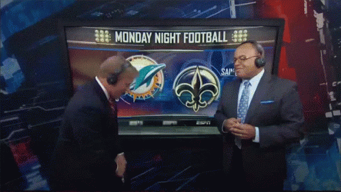 Two Men in Front of TV Showing Monday Night Football