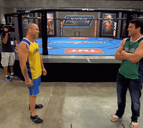 Two Men in Front of UFC Cage