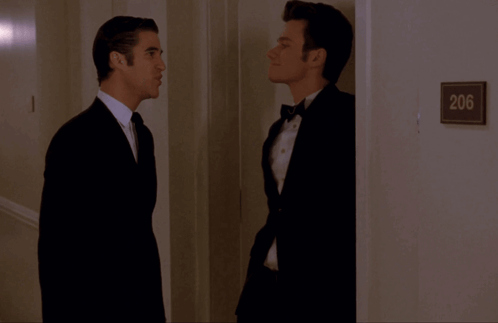 Two Men in Hallway With Sign 206