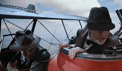Two Men in Hats Sitting in Plane