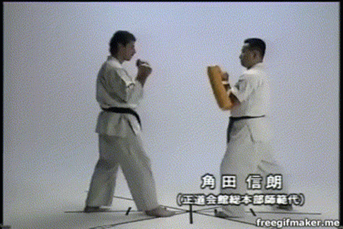 Two Men In Karate Uniforms Are Standing Next To Each Other And Their Names Are Written In Chinese GIF