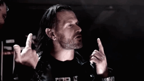Two Men In Leather Jackets Are Giving The Middle Finger In A Dark Room GIF
