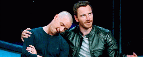 Two Men In Leather Jackets Are Sitting Next To Each Other GIF