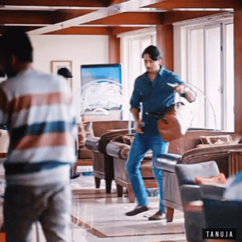 Two Men in Living Room with Tanuja Logo