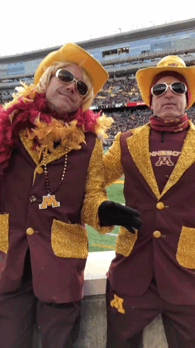 Two Men in Maroon and Gold Outfits With M