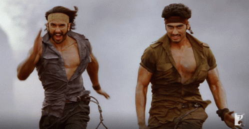 Two Men In Military Uniforms Are Running And One Has A Headband On His Head GIF