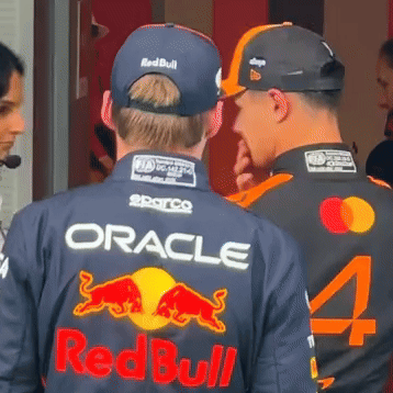 Two Men In Oracle And Redbull Jerseys Talking GIF