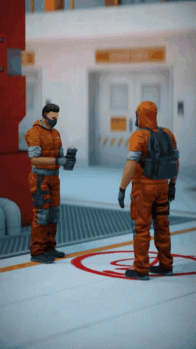 Two Men In Orange Jumpsuits Are Standing Next To Each Other In A Room GIF