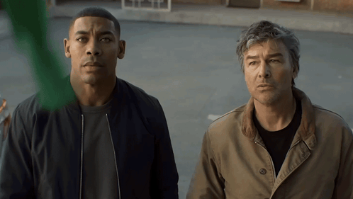 Two Men In Parking Lot Looking At Something GIF