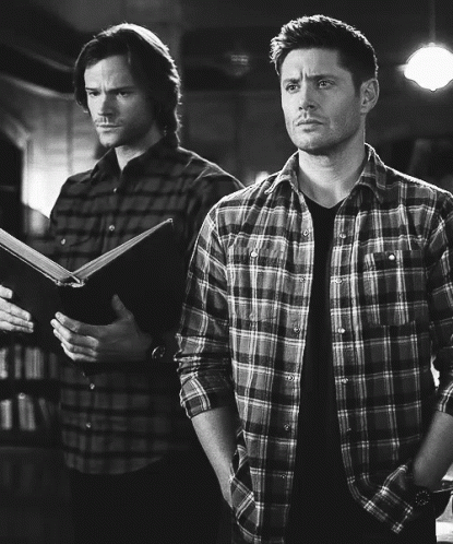 Two Men in Plaid Shirts One Holding Book