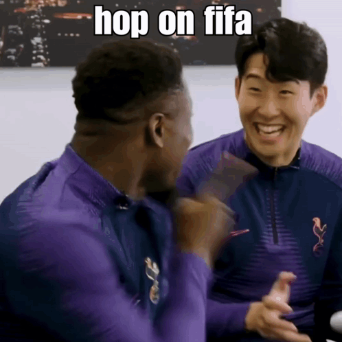 Two Men In Purple Shirts Are Laughing And One Of Them Says Hop On Fifa GIF
