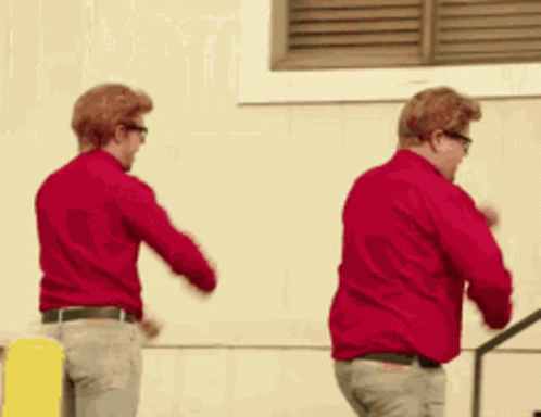 Two Men in Red Shirts Dancing