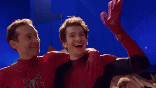 Two Men In Spiderman Costumes Are Hugging Each Other And Smiling GIF