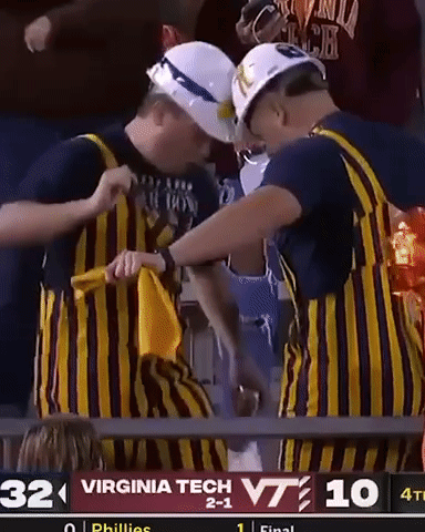 Two Men in Striped Overalls at Virginia Tech Sign