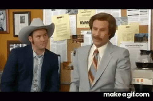 Two Men In Suits And Cowboy Hats Are Standing Next To Each Other And Talking . GIF