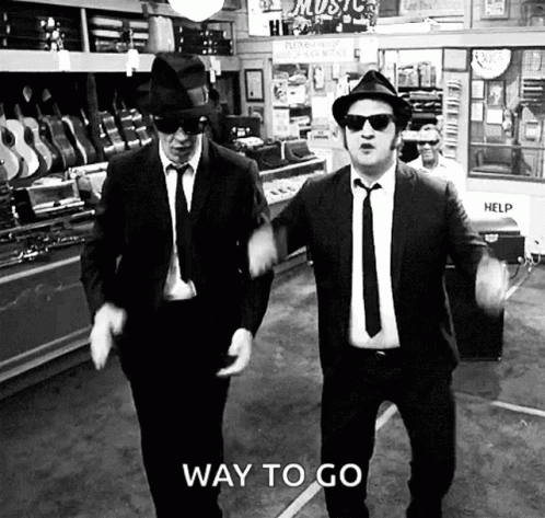 Two Men in Suits and Hats Dancing With Way to Go