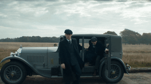 Two Men In Suits And Hats Getting Out Of Gray Car GIF