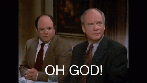 Two Men In Suits And Ties Are Sitting At A Table With A Glass Of Wine And A Sign That Says `` Oh God '' . GIF