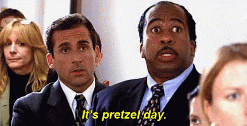 Two Men In Suits And Ties Are Sitting In Front Of A Crowd Of People . GIF