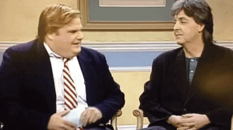 Two Men In Suits And Ties Are Sitting Next To Each Other In Chairs And Talking . GIF