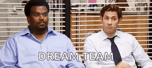 Two Men In Suits And Ties Are Sitting Next To Each Other In Front Of A Window With Blinds . GIF
