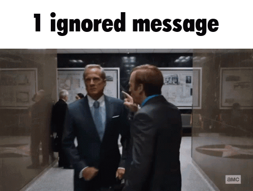 Two Men In Suits And Ties Are Standing In A Hallway With The Words 1 Ignored Message Above Them GIF