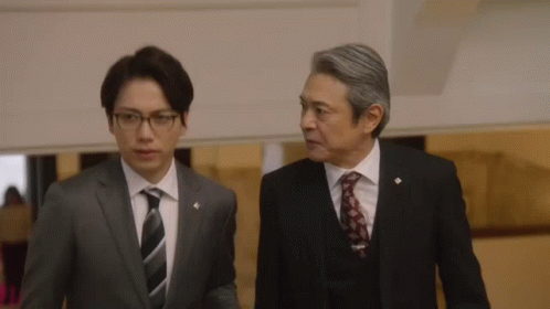 Two Men In Suits Talking GIF