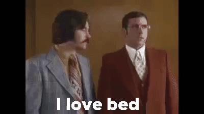 Two Men In Suits And Ties Are Standing Next To Each Other And They Are Talking About Bed . GIF