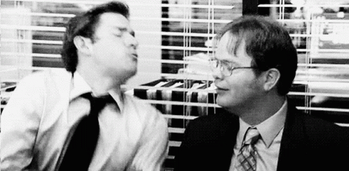 Two Men In Suits And Ties Are Standing Next To Each Other In An Office . GIF
