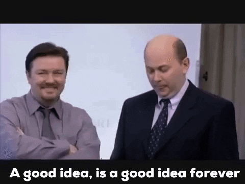 Two Men In Suits And Ties Are Standing Next To Each Other In Front Of A White Board . GIF