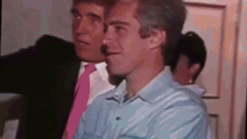 Two Men In Suits And Ties Are Standing Next To Each Other . One Of The Men Is Wearing A Pink Tie . GIF