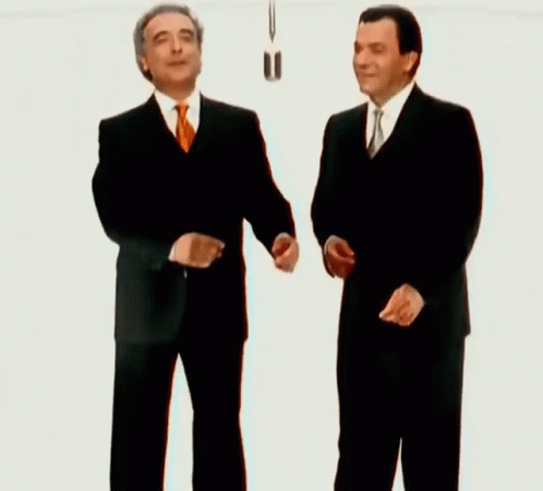Two Men In Suits Shaking Hands GIF