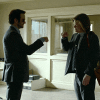Two Men In Suits And Ties Are Standing Next To Each Other Talking GIF