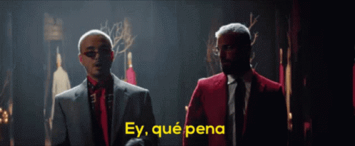 Two Men In Suits And Ties Are Standing Next To Each Other With The Words Ey Qué Pena Written In Yellow GIF