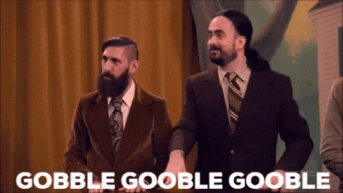 Two Men In Suits Standing With Gobble Goolbe Goolbe Text GIF