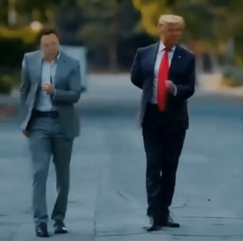 Two Men In Suits And Ties Are Walking Down The Street . GIF