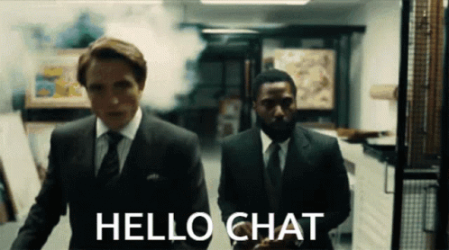 Two Men In Suits And Ties Are Walking In A Hallway With The Words Hello Chat On The Bottom GIF