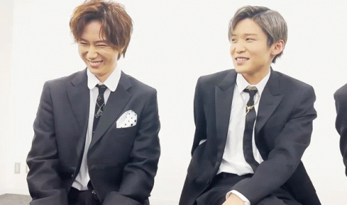 Two Men in Suits and Ties Sitting Together