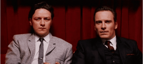 Two Men In Suits And Ties Sitting Together GIF
