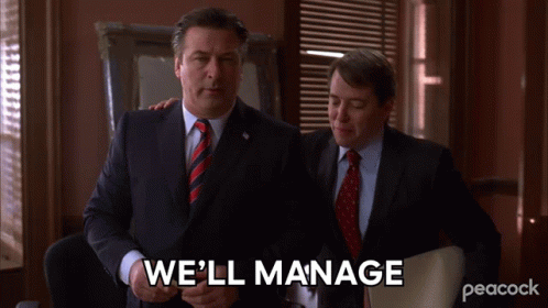 Two Men In Suits And Ties Standing Next To Each Other With The Words We 'Ll Manage Written On The Screen GIF
