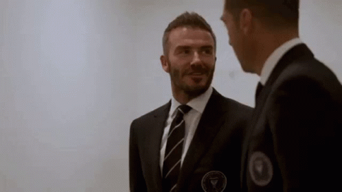 Two Men in Suits and Ties Talking