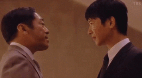 Two Men in Suits and Ties Talking