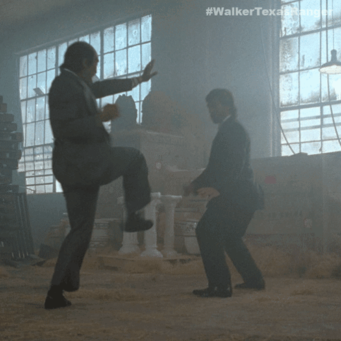 Two Men In Suits Are Dancing In A Dark Room With The Hashtag #Walkertexasrangers GIF