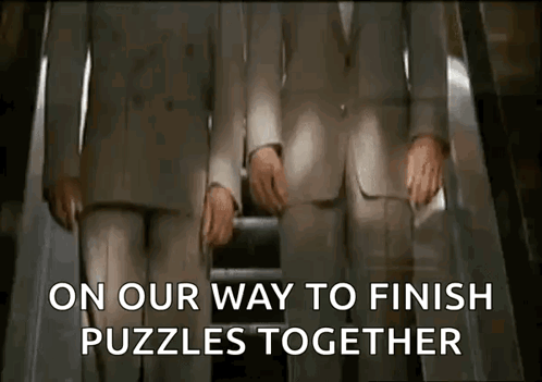 Two Men In Suits Are Riding An Escalator And The Words On Our Way To Finish Puzzles Together Are Displayed GIF