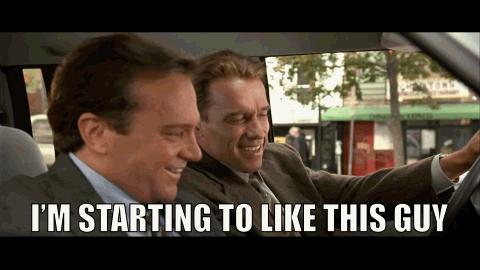 Two Men In Suits Are Sitting In A Car And One Of Them Is Saying I 'M Starting To Like This Guy GIF